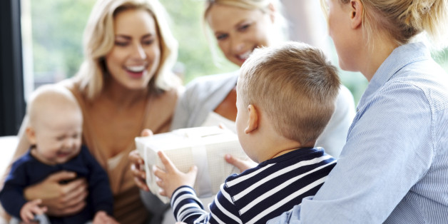 Little boy receiving gift from a woman